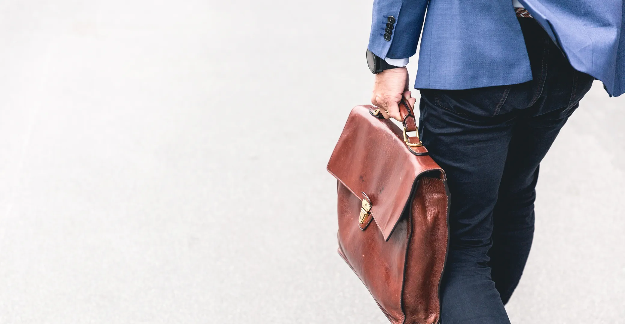 Businessman walking with a briefcase, embodying purpose and professionalism on the move