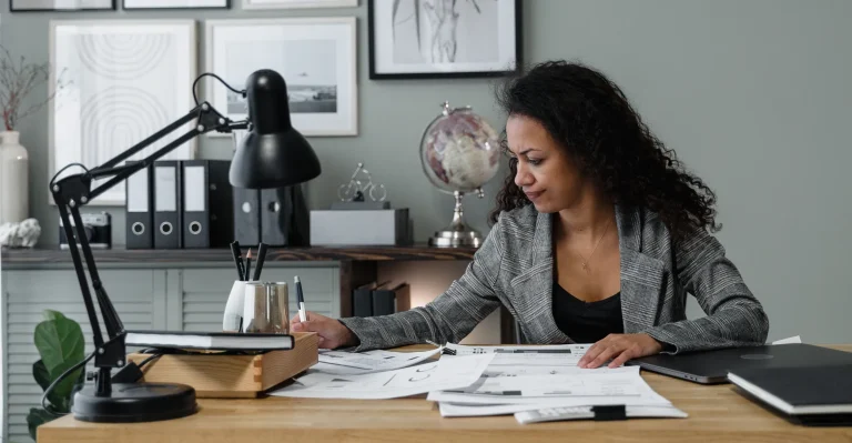 Businesswoman at her desk, actively working with documents