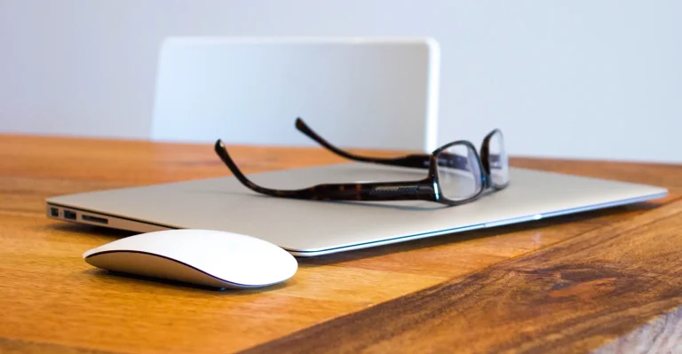 Glasses resting on a laptop keyboard, symbolizing focused attention and strategic planning