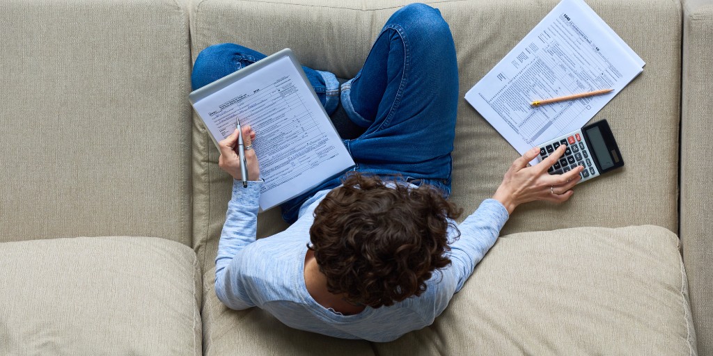 Top view of home owner working on their taxes